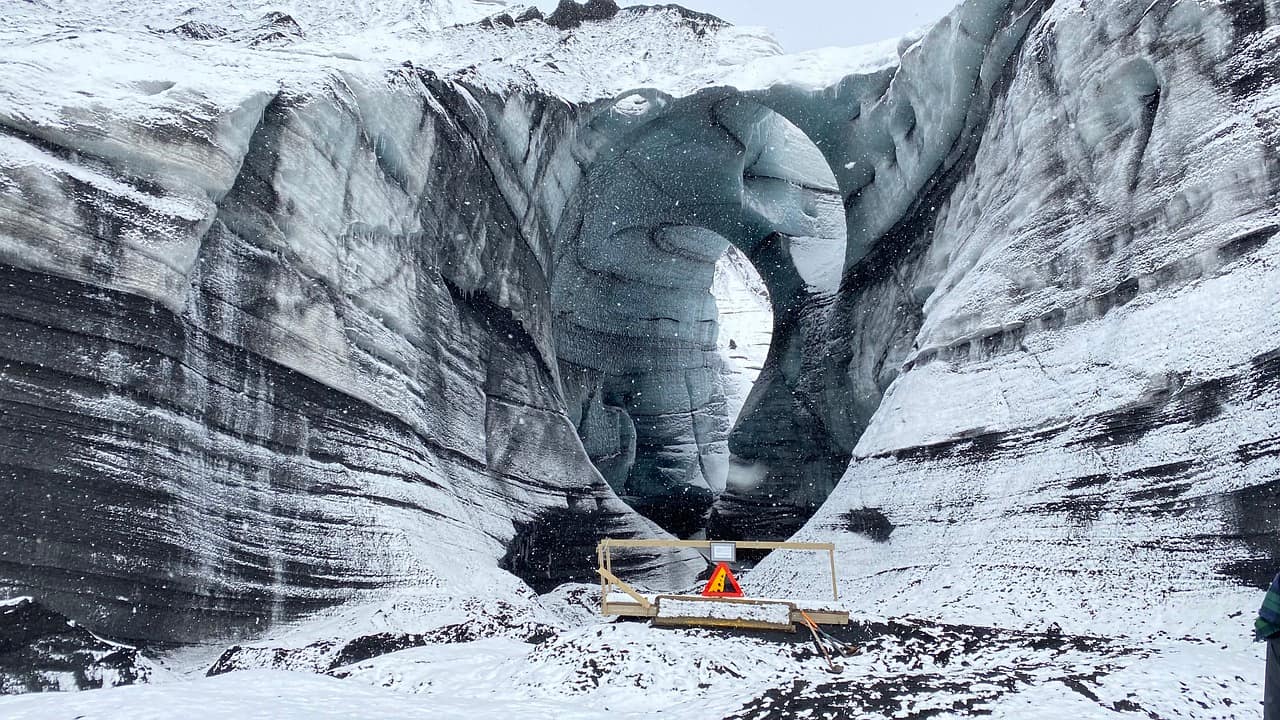 Blue ice cave under a glacier in Iceland in winter