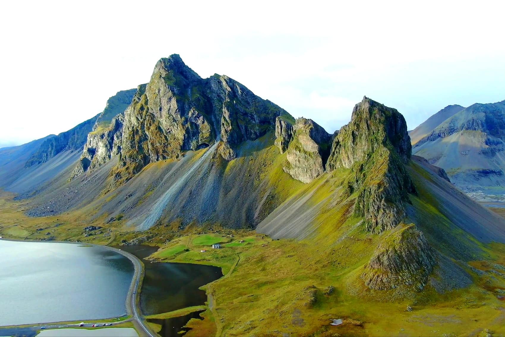 The jagged peaks of Vestrahorn rising above a still coastal lagoon