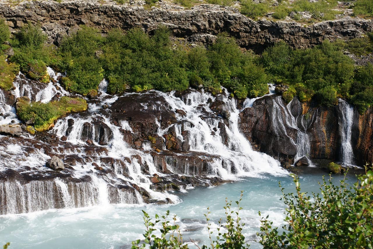 Hraunfossar waterfalls streaming out of the lava field in West Iceland